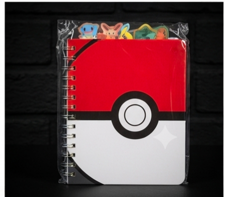Pokémon Pokéball spiral notebook with character tab dividers on dark background